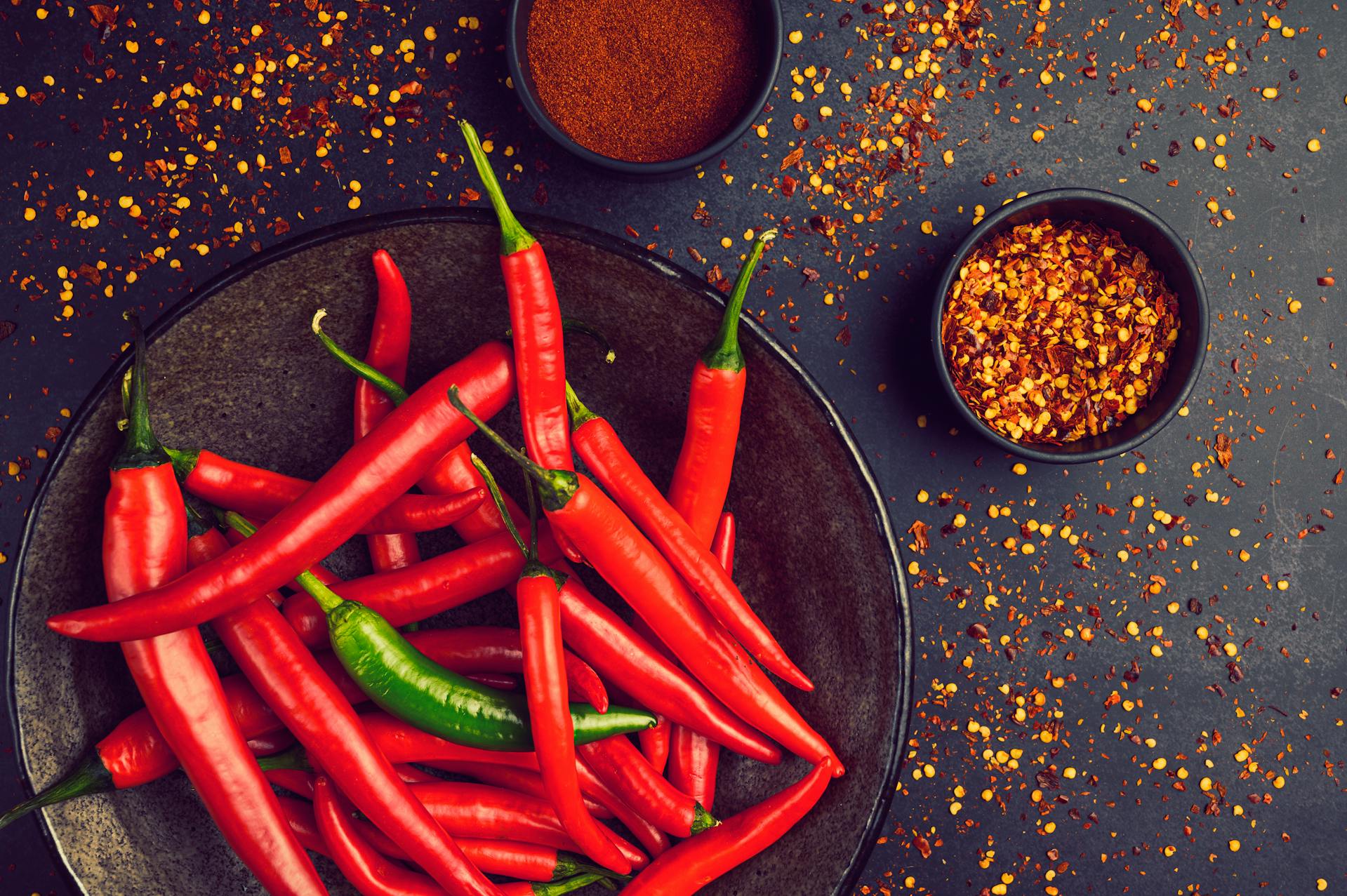 Cayenne pepper powder in wooden spoon -- natural detox remedy